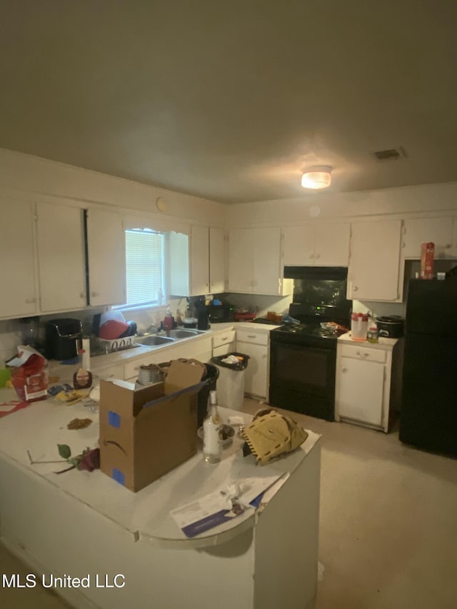 351 E Academy St, Canton, MS 39046 - kitchen with black appliances, white cabinets, a sink, and light countertops