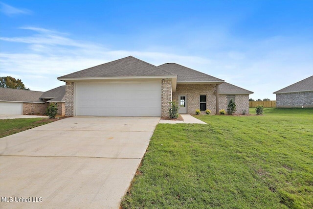 view of front of property featuring a garage and a front lawn