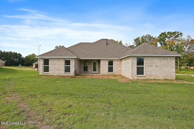 rear view of house featuring a yard