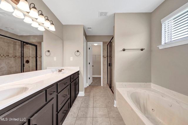 2338 Khushboo Cv, Southaven, MS 38671 - bathroom with a stall shower, double vanity, a jetted tub, and tile patterned flooring