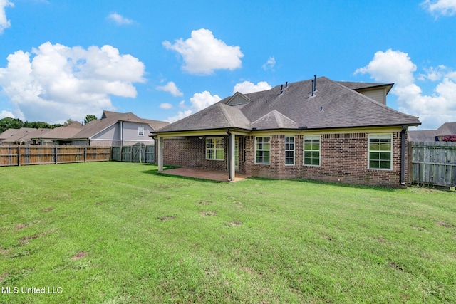 2338 Khushboo Cv, Southaven, MS 38671 - rear view of house featuring brick siding, a patio area, a fenced backyard, and a shingled roof