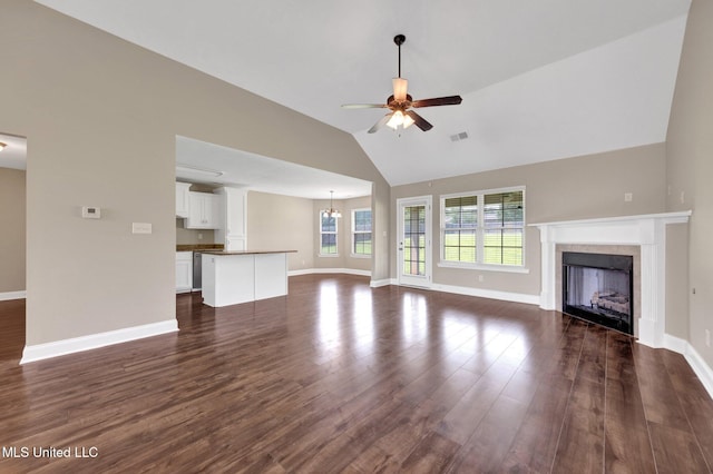 2338 Khushboo Cv, Southaven, MS 38671 - unfurnished living room featuring a ceiling fan, a fireplace, dark wood-type flooring, a chandelier, and high vaulted ceiling