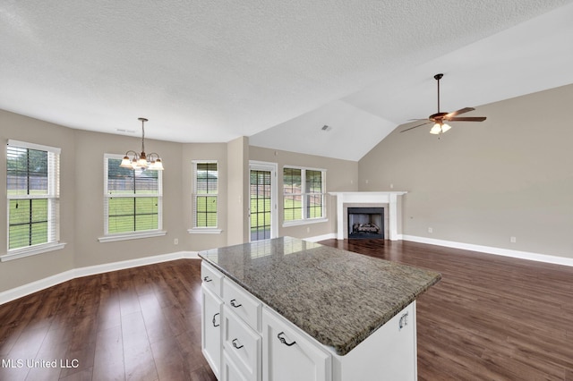 2338 Khushboo Cv, Southaven, MS 38671 - kitchen with open floor plan, a center island, dark wood-type flooring, a chandelier, and a textured ceiling