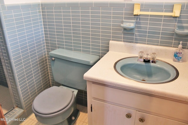 bathroom featuring vanity, toilet, tile walls, tile patterned floors, and tasteful backsplash
