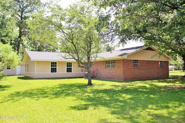 exterior space featuring a lawn and central air condition unit