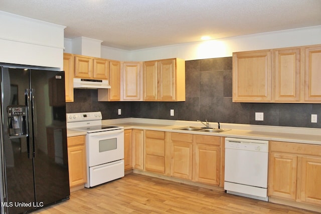 kitchen with light wood-type flooring, a sink, light brown cabinets, under cabinet range hood, and white appliances