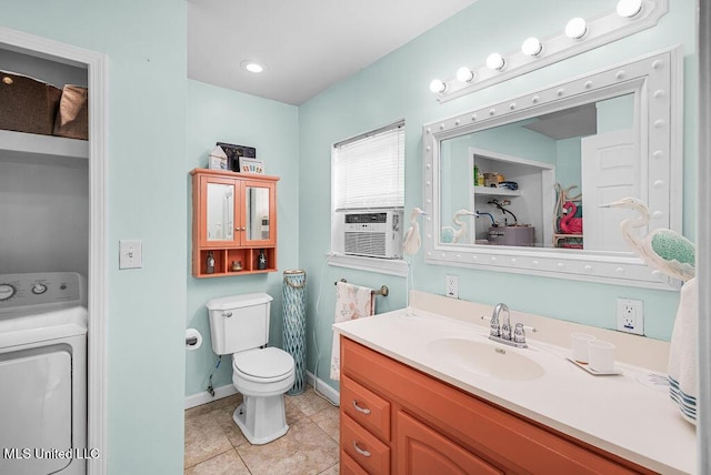 bathroom with washer / clothes dryer, vanity, tile patterned flooring, and toilet