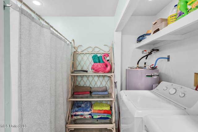 laundry room with water heater and separate washer and dryer