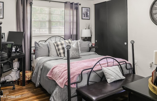 bedroom featuring a closet and wood finished floors
