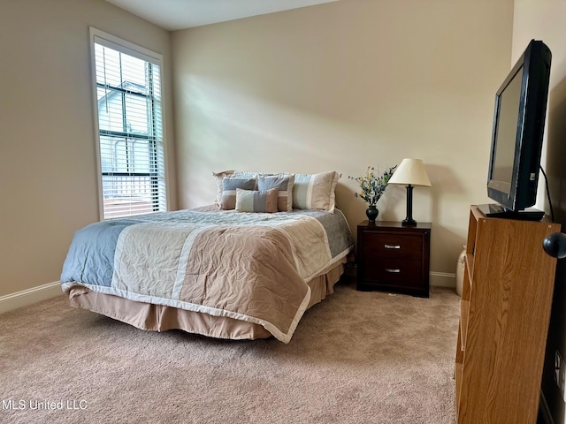 bedroom featuring light colored carpet