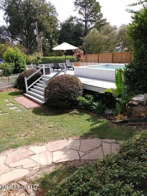 view of yard featuring a fenced in pool and a fenced backyard