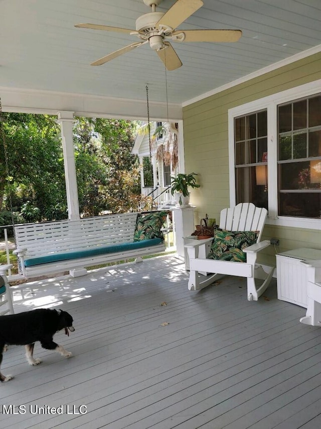 wooden terrace featuring a ceiling fan