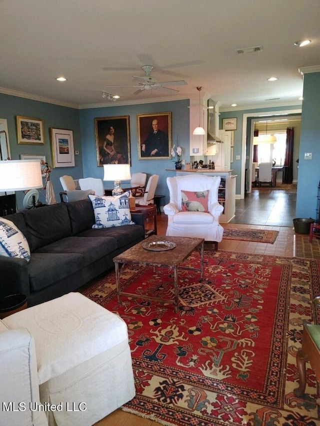 living area featuring ceiling fan, visible vents, ornamental molding, and recessed lighting