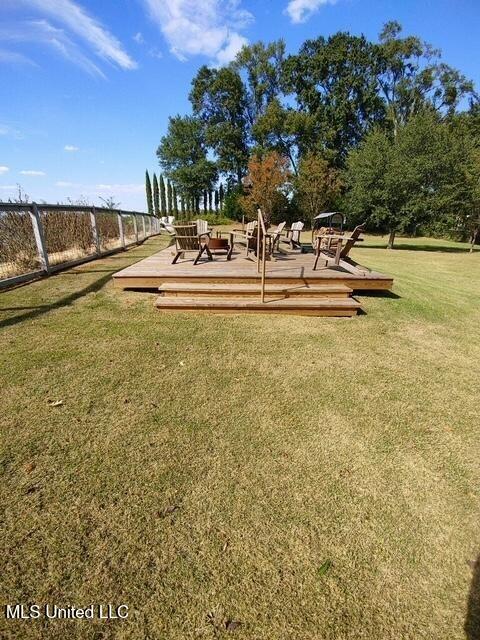 surrounding community with a lawn and a wooden deck