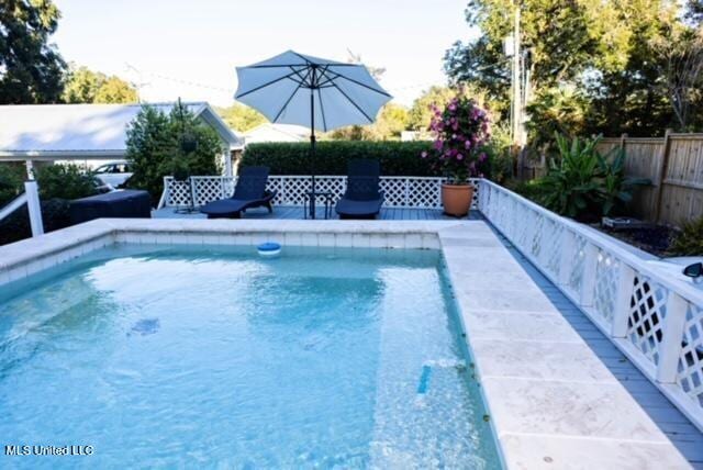 view of swimming pool featuring fence and a fenced in pool