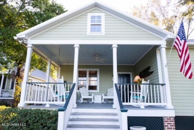 view of front of property featuring stairway and a porch