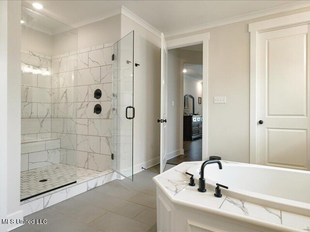 bathroom with ornamental molding and independent shower and bath