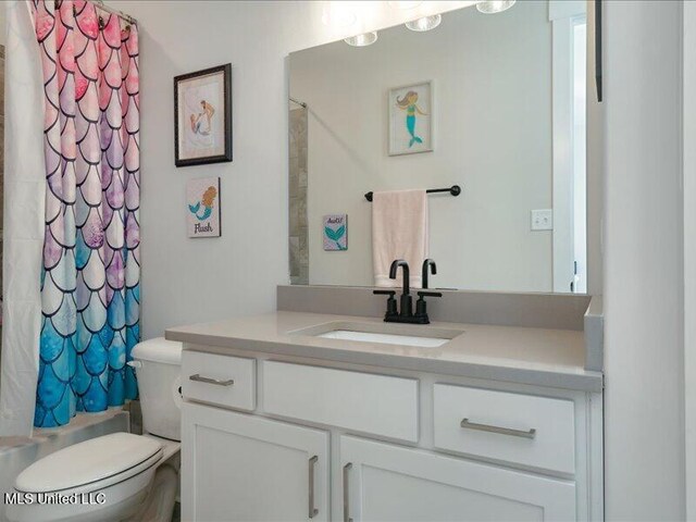 full bathroom with vanity, toilet, and shower / tub combo with curtain