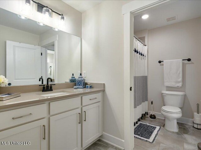 bathroom with tile patterned flooring, vanity, toilet, and a shower with shower curtain