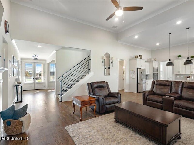 living room featuring hardwood / wood-style floors, french doors, ornamental molding, and ceiling fan