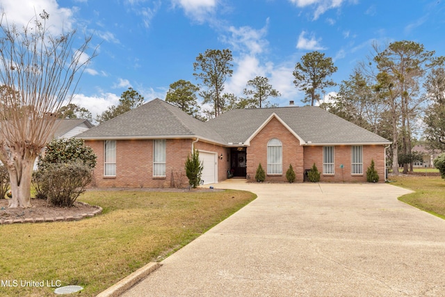 single story home featuring brick siding, an attached garage, concrete driveway, and a front yard