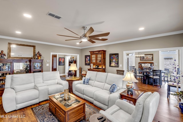 living room featuring recessed lighting, wood finished floors, visible vents, and ornamental molding