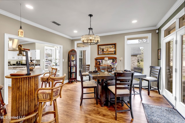 dining room with visible vents, plenty of natural light, and light wood finished floors