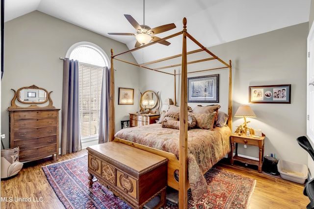 bedroom with vaulted ceiling, wood finished floors, and ceiling fan