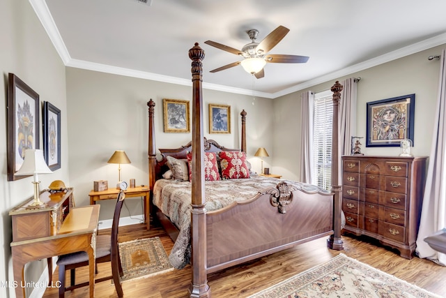 bedroom featuring ceiling fan, wood finished floors, baseboards, and ornamental molding