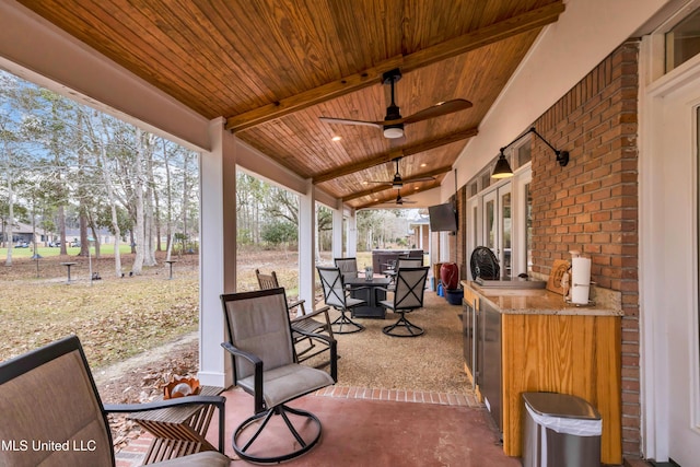 view of patio / terrace with outdoor dining space, area for grilling, and a ceiling fan