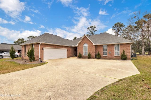 single story home featuring brick siding, concrete driveway, an attached garage, and a shingled roof