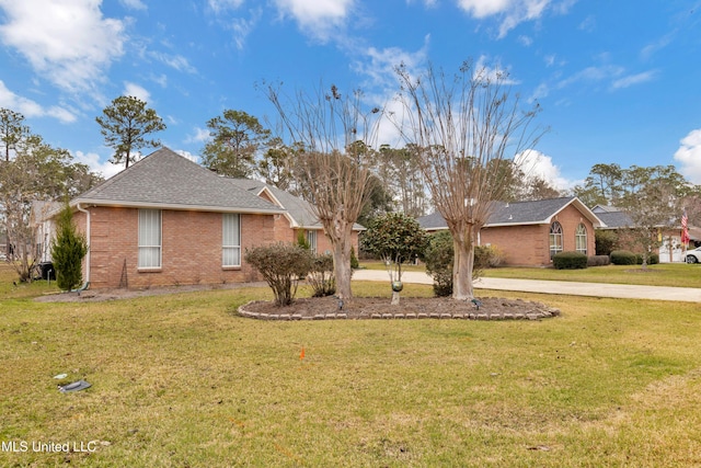 single story home with a front lawn, brick siding, and roof with shingles