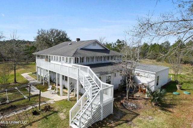 6131 Jenness Rd, Pearlington, MS 39572 - back of house with a patio area, roof with shingles, stairway, a yard, and a deck
