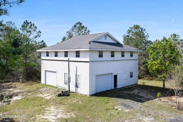 6131 Jenness Rd, Pearlington, MS 39572 - view of home's exterior with a garage and a shingled roof