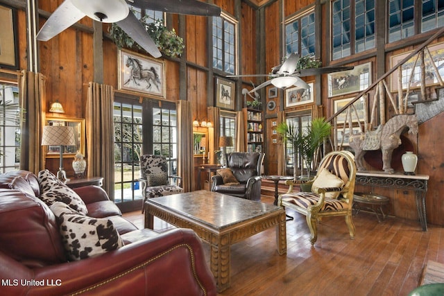 6131 Jenness Rd, Pearlington, MS 39572 - home office featuring ceiling fan, wooden walls, a towering ceiling, and wood-type flooring