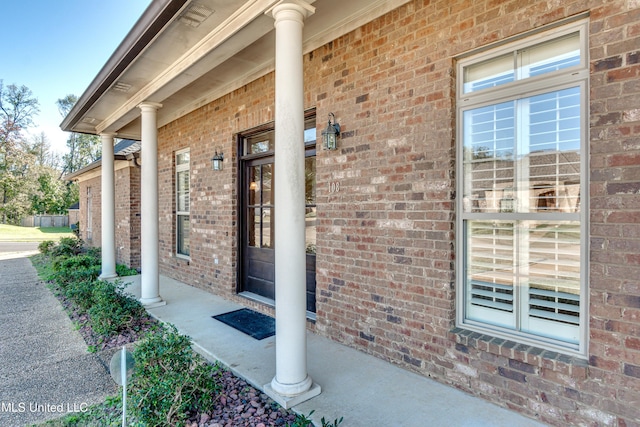 view of exterior entry with a porch