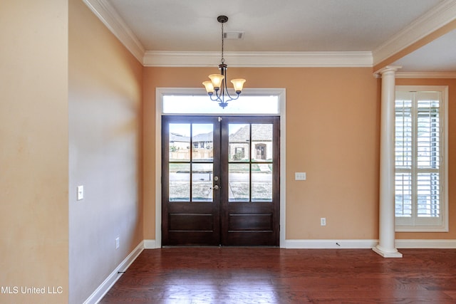 foyer entrance featuring french doors, dark hardwood / wood-style flooring, decorative columns, and ornamental molding