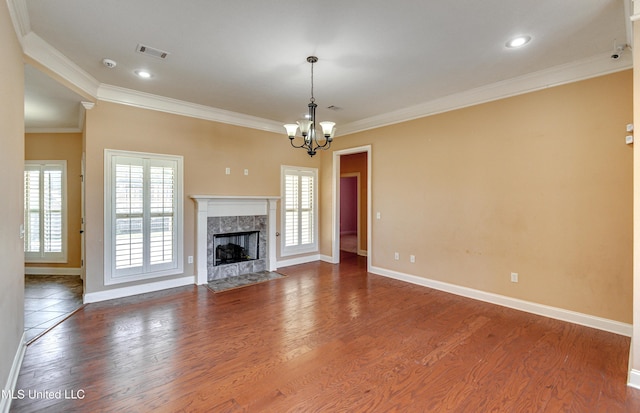 unfurnished living room featuring a fireplace, hardwood / wood-style flooring, a wealth of natural light, and ornamental molding