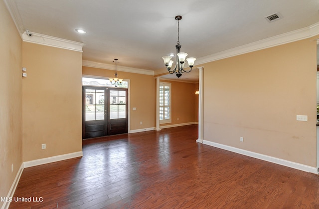 unfurnished room featuring a chandelier, french doors, ornamental molding, and dark wood-type flooring