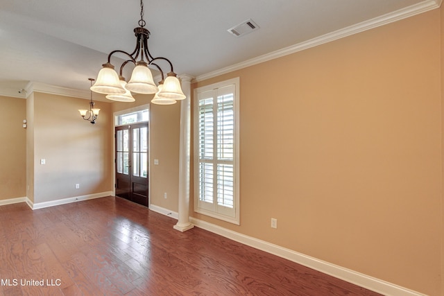 interior space featuring hardwood / wood-style flooring, french doors, crown molding, and an inviting chandelier