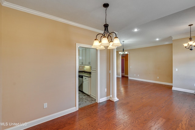 unfurnished dining area with a notable chandelier, wood-type flooring, and crown molding