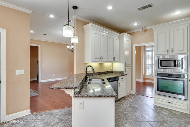 kitchen featuring kitchen peninsula, stainless steel appliances, sink, light hardwood / wood-style flooring, and white cabinets