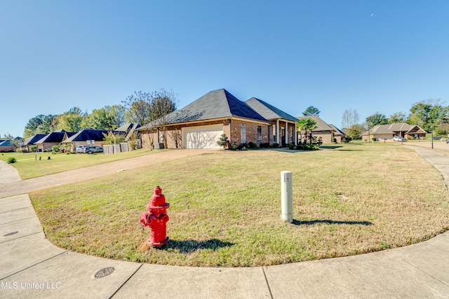 view of front of house with a garage and a front lawn