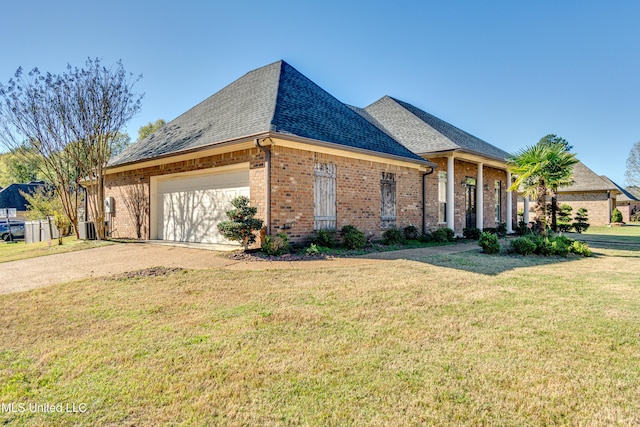 view of front facade featuring a front yard, a garage, and central air condition unit