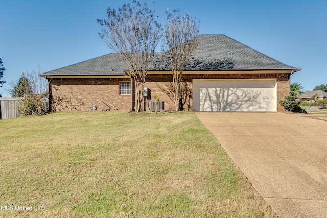 ranch-style house featuring central AC unit, a garage, and a front lawn