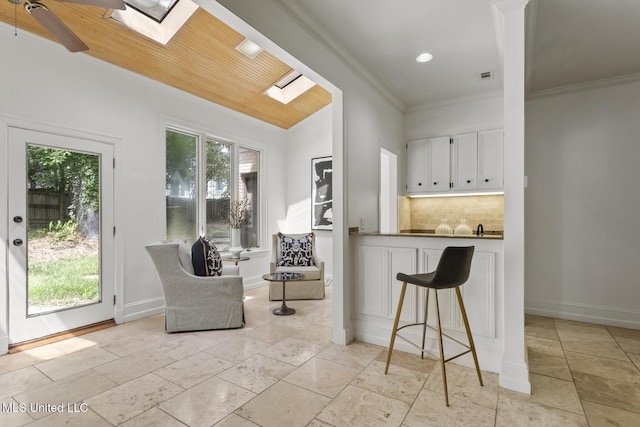 13 Highland Meadows Dr, Jackson, MS 39211 - living area with a skylight, plenty of natural light, ornamental molding, recessed lighting, and ceiling fan