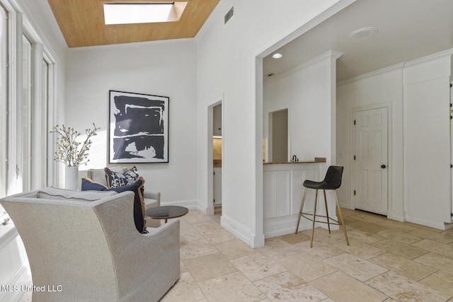 13 Highland Meadows Dr, Jackson, MS 39211 - living room featuring a skylight, crown molding, and stone tile flooring