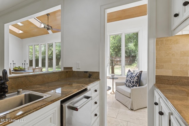 13 Highland Meadows Dr, Jackson, MS 39211 - kitchen with dishwasher, healthy amount of natural light, a ceiling fan, white cabinetry, and ornamental molding