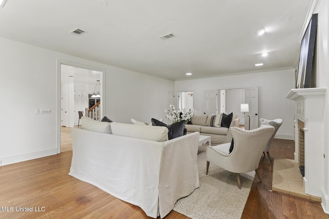 13 Highland Meadows Dr, Jackson, MS 39211 - living area featuring crown molding, wood finished floors, stairs, recessed lighting, and a fireplace with flush hearth