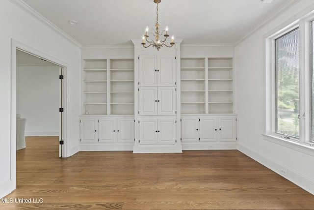 13 Highland Meadows Dr, Jackson, MS 39211 - unfurnished dining area with a chandelier, built in shelves, crown molding, and wood finished floors